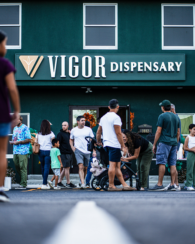 Street view of Vigor Dispensary in Matawan with people gathered in front of the store.